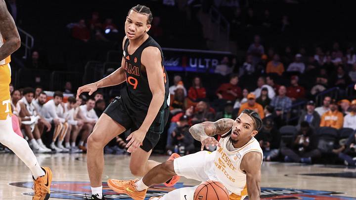 Dec 10, 2024; New York, New York, USA;  Miami Hurricanes guard Divine Ugochukwu (99) collides with Tennessee Volunteers guard Zakai Zeigler (5) in the first half at Madison Square Garden. Mandatory Credit: Wendell Cruz-Imagn Images