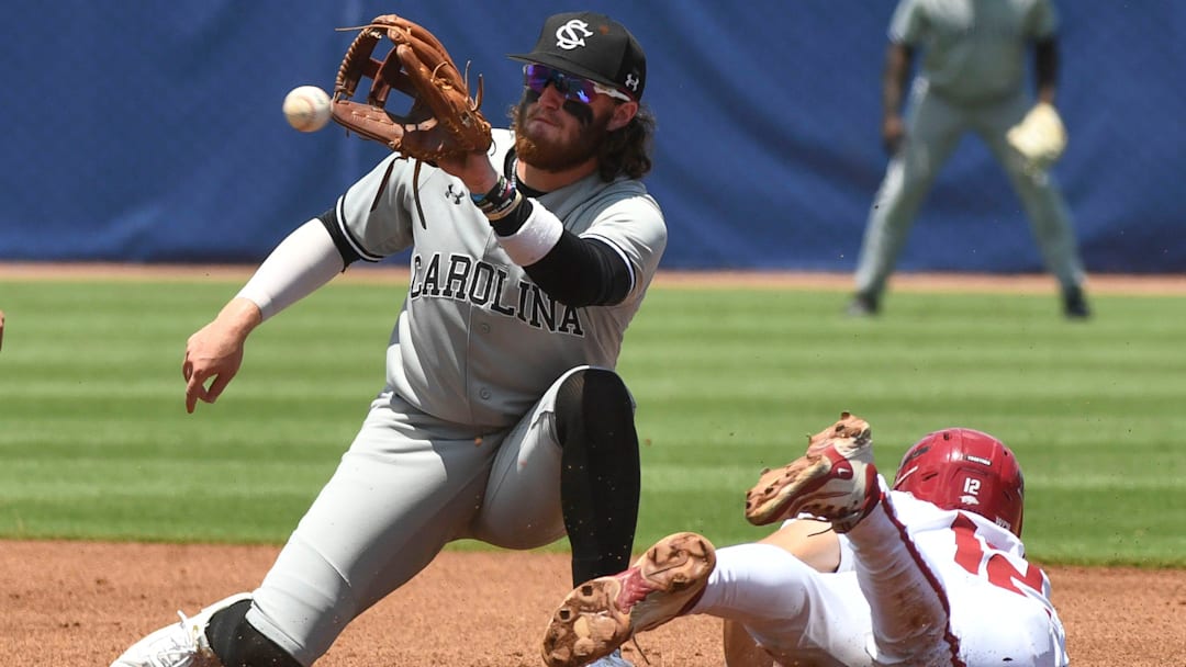 May 22 2024; Hoover, AL, USA; South Carolina shortstop Talmadge LeCroy takes a throw too late to catch Arkansas base runner Jared Sprague-Lott as he steals second at the Hoover Met during the SEC Tournament.