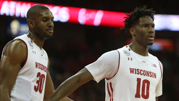 Wisconsin Badgers forward Vitto Brown (30) and forward Nigel Hayes (10) walk off the court