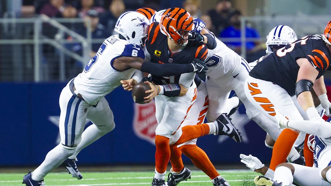 Dec 9, 2024; Arlington, Texas, USA;  Dallas Cowboys safety Donovan Wilson (6) tackles Cincinnati Bengals quarterback Joe Burrow (9) during the second half at AT&T Stadium. Mandatory Credit: Kevin Jairaj-Imagn Images