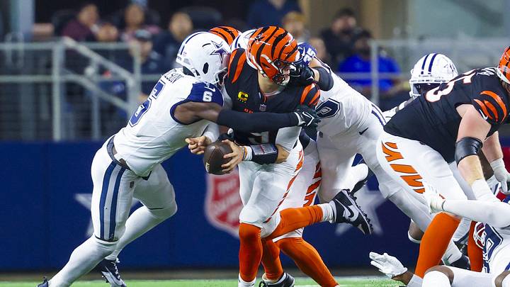 Dec 9, 2024; Arlington, Texas, USA;  Dallas Cowboys safety Donovan Wilson (6) tackles Cincinnati Bengals quarterback Joe Burrow (9) during the second half at AT&T Stadium. Mandatory Credit: Kevin Jairaj-Imagn Images