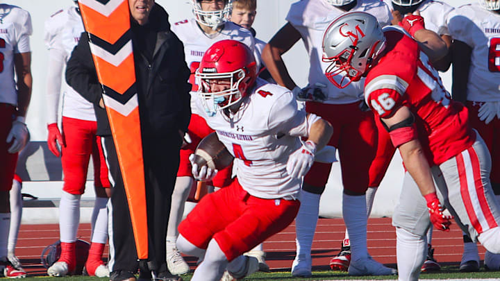 Bridgewater-Raynham's Dylan Reed looks to avoid Catholic Memorial's Jack Daley after hauling in a catch during an MIAA Division 2 Quarterfinal on Nov. 16, 2024.