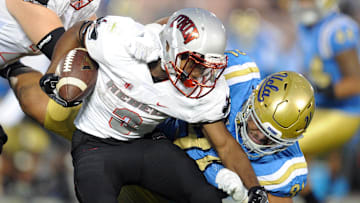 September 10, 2016; Pasadena, CA, USA;  UNLV Rebels running back Lexington Thomas (3) runs the ball against the defense of UCLA Bruins defensive lineman Jacob Tuioti-Mariner (91) during the second half at Rose Bowl. Mandatory Credit: Gary A. Vasquez-Imagn Images

