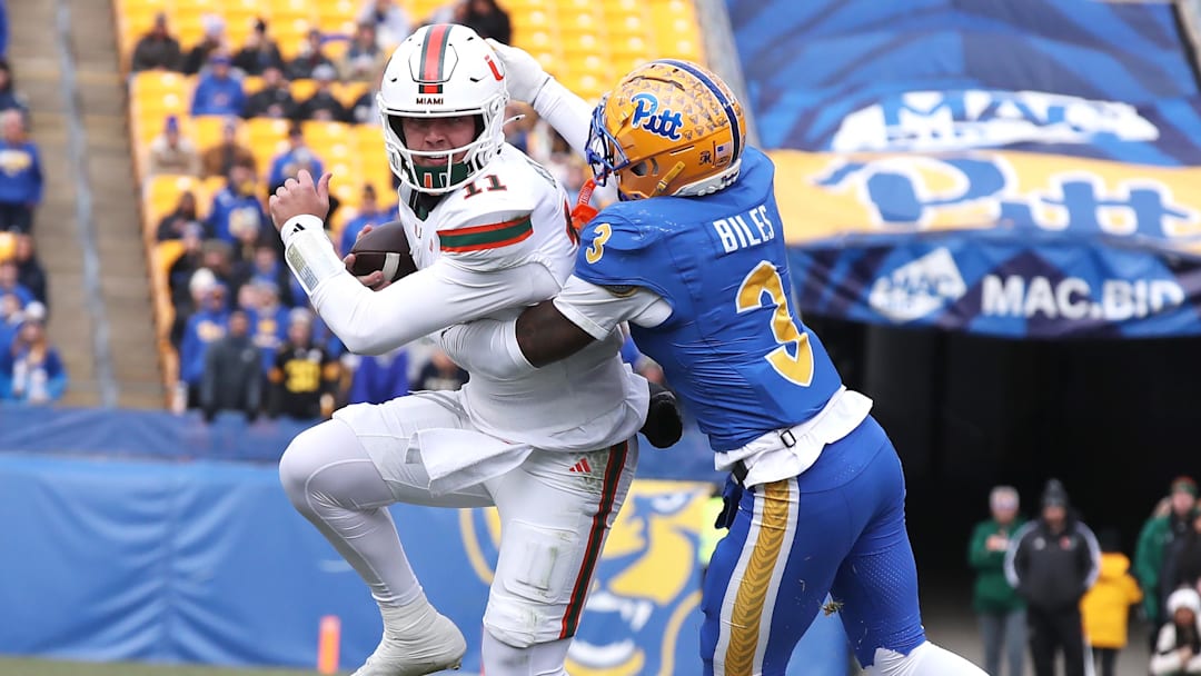 Nov 29, 2025; Pittsburgh, Pennsylvania, USA;  Miami Hurricanes quarterback Carson Beck (11) runs the ball as Pittsburgh Panthers linebacker Rasheem Biles (3) tackles during the first quarter at Acrisure Stadium. Mandatory Credit: Charles LeClaire-Imagn Images