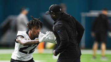 Jacksonville Jaguars cornerback Jarrian Jones (22) runs a drill around defensive assistant/cornerbacks coach Corey Robinson during Friday's rookie minicamp session. The Jacksonville Jaguars held their first day of rookie minicamp inside the covered field at the Jaguars performance facility in Jacksonville, Florida Friday, May 10, 2024.