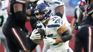 Dec 8, 2024; Glendale, Arizona, USA; Seattle Seahawks running back Zach Charbonnet (26) against the Arizona Cardinals at State Farm Stadium. Mandatory Credit: Mark J. Rebilas-Imagn Images