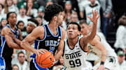 Michigan State guard Divine Ugochukwu (99) defends Duke guard Cayden Boozer (2) during the first half at Breslin Center in East Lansing on Saturday, Dec. 6, 2025.