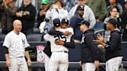 New York Yankees first baseman Mark Teixeira (25) is embraced by starting pitcher CC Sabathia (52) after being removed from his final Major League game against the Baltimore Orioles at Yankee Stadium on Oct. 2, 2016.