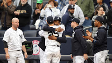 New York Yankees first baseman Mark Teixeira (25) is embraced by starting pitcher CC Sabathia (52) after being removed from his final Major League game against the Baltimore Orioles at Yankee Stadium on Oct. 2, 2016.