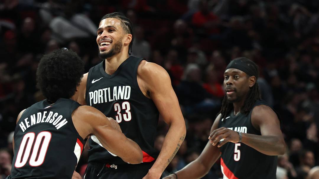 Mar 23, 2026; Portland, Oregon, USA; Portland Trail Blazers guard Scoot Henderson (00) hugs teammate forward Toumani Camara (33) after scoring against the Brooklyn Nets during the second half at Moda Center. Mandatory Credit: Jaime Valdez-Imagn Images