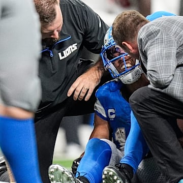 Detroit Lions staff check on wide receiver Amon-Ra St. Brown (14).