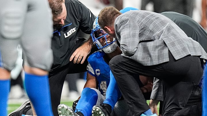 Detroit Lions staff check on wide receiver Amon-Ra St. Brown (14).