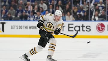 Apr 24, 2024; Toronto, Ontario, CAN; Boston Bruins defenseman Mason Lohrei (6) shoots the puck against the Toronto Maple Leafs in game three of the first round of the 2024 Stanley Cup Playoffs at Scotiabank Arena. Mandatory Credit: John E. Sokolowski-Imagn Images