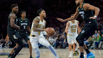 Nov 29, 2025; Minneapolis, Minnesota, USA; Boston Celtics guard Anfernee Simons (4) is guarded by Minnesota Timberwolves center Rudy Gobert (27) in the first quarter at Target Center. 