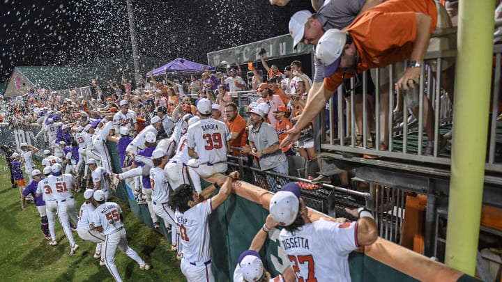 Jun 2, 2024; Clemson, South Carolina, USA; Clemson players run to the Cheap Seats section and Cajun Cafe celebrating with fans after defeating Coastal Carolina at the Clemson Regional at Doug Kingsmore Stadium. Mandatory Credit: Ken Ruinard-USA TODAY Sports