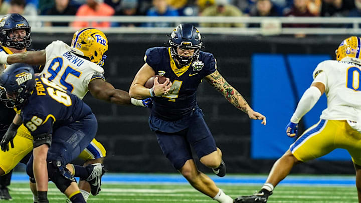 Toledo Rockets quarterback Tucker Gleason (4) runs for the first down, during the first half of the 2024 GameAbove Sports Bowl at Ford Field in Detroit, Thursday, Dec. 26, 2024. Toledo Rockets quarterback Tucker Gleason (4) runs for the first down, during the first half of the 2024 GameAbove Sports Bowl at Ford Field in Detroit, Thursday, Dec. 26, 2024.