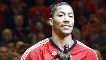 May 4, 2011; Chicago, IL, USA; Chicago Bulls point guard Derrick Rose (1) is presented the MVP trophy before game two of the second round of the 2011 NBA playoffs against the Atlanta Hawks at the United Center. Mandatory Credit: Mike DiNovo-Imagn Images