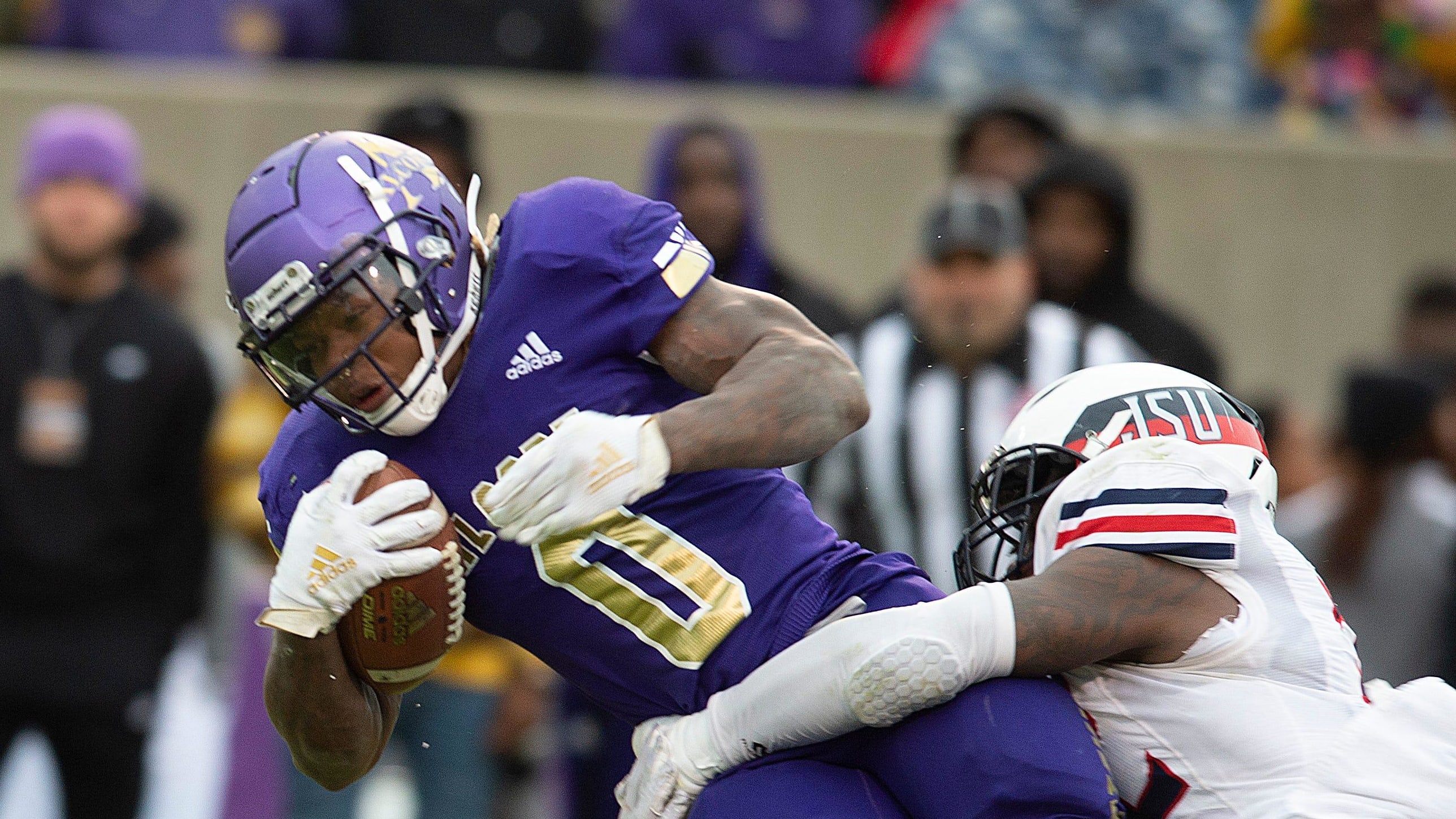 Alcorn State running back Jarveon Howard (0) gets taken down by Jackson State linebacker Jurriente