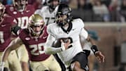 Nov 1, 2025; Tallahassee, Florida, USA; Wake Forest Demon Deacons quarterback Robby Ashford (2) runs the ball past Florida State Seminoles linebacker Blake Nichelson (20) during the first quarter at Doak S. Campbell Stadium. Mandatory Credit: Melina Myers-Imagn Images