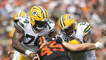 Sep 21, 2025; Cleveland, Ohio, USA; Green Bay Packers running back Josh Jacobs (8) runs the ball as guard Elgton Jenkins (74) blocks Cleveland Browns linebacker Carson Schwesinger (49) during the third quarter at Huntington Bank Field. Mandatory Credit: Scott Galvin-Imagn Images