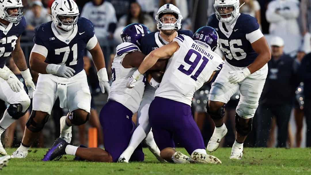 Penn State Nittany Lions quarterback Ethan Grunkemeyer (17) is tackled by Northwestern Wildcats defensive linesman Aidan Hubbard (91).