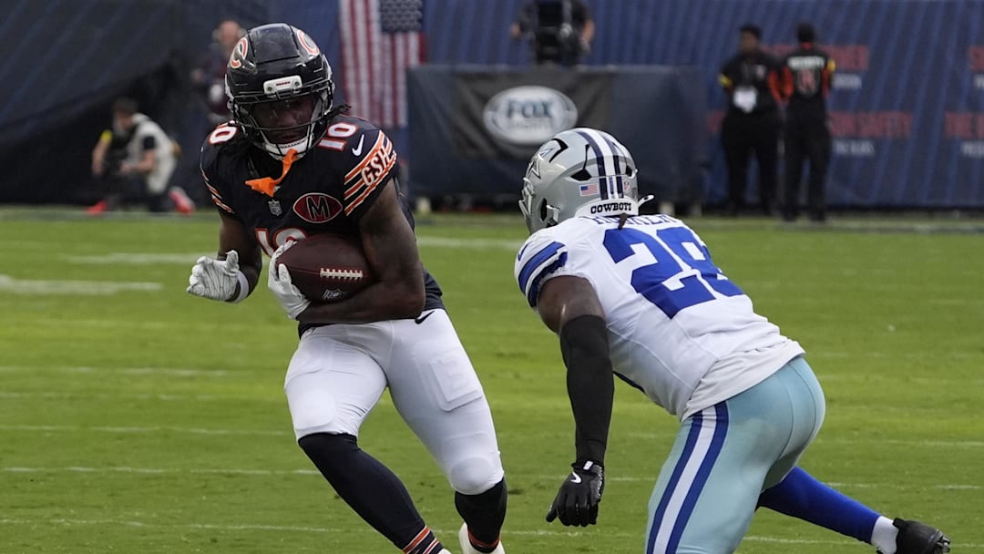 Sep 21, 2025; Chicago, Illinois, USA; Dallas Cowboys free safety Malik Hooker (28) tackles Chicago Bears wide receiver Luther Burden III (10) during the second half at Soldier Field. Mandatory Credit: David Banks-Imagn Images