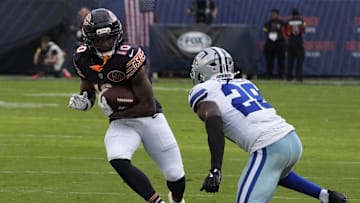 Sep 21, 2025; Chicago, Illinois, USA; Dallas Cowboys free safety Malik Hooker (28) tackles Chicago Bears wide receiver Luther Burden III (10) during the second half at Soldier Field. Mandatory Credit: David Banks-Imagn Images