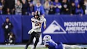 Oct 18, 2024; Provo, Utah, USA; Oklahoma State Cowboys quarterback Garret Rangel (13) runs the ball past Brigham Young Cougars safety Micah Harper (1) during the second quarter at LaVell Edwards Stadium. Mandatory Credit: Rob Gray-Imagn Images