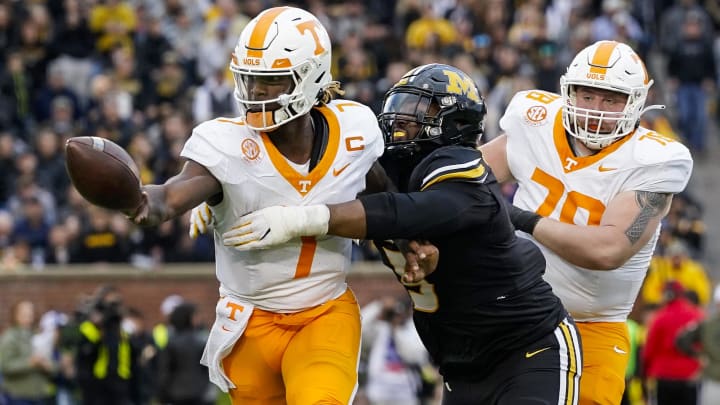 Nov 11, 2023; Columbia, Missouri, USA; Tennessee Volunteers quarterback Joe Milton III (7) pitches the ball as he is hit by Missouri Tigers defensive lineman Kristian Williams (5) during the second half at Faurot Field at Memorial Stadium. Mandatory Credit: Jay Biggerstaff-USA TODAY Sports