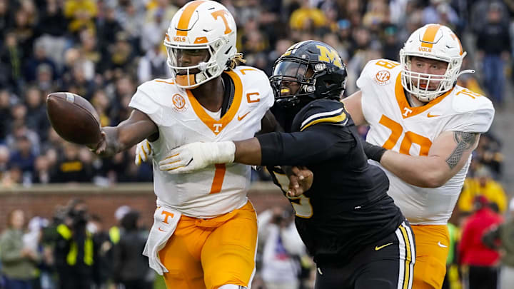 Nov 11, 2023; Columbia, Missouri, USA; Tennessee Volunteers quarterback Joe Milton III (7) pitches the ball as he is hit by Missouri Tigers defensive lineman Kristian Williams (5) during the second half at Faurot Field at Memorial Stadium. Mandatory Credit: Jay Biggerstaff-Imagn Images