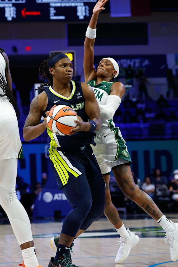 Dallas Wings forward Myisha Hines-Allen looks to pass against Seattle Storm guard Brittney Sykes