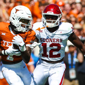 Oct 7, 2023; Dallas, Texas, USA;  Texas Longhorns wide receiver Xavier Worthy (1) runs with the ball as Oklahoma Sooners defensive back Key Lawrence (12) chases during the first half at the Cotton Bowl. Mandatory Credit: Kevin Jairaj-Imagn Images
