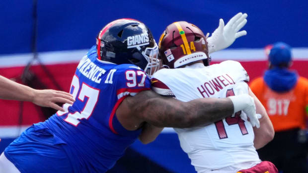 New York Giants defensive tackle Dexter Lawrence sacks former Washington Commanders quarterback Sam Howell.