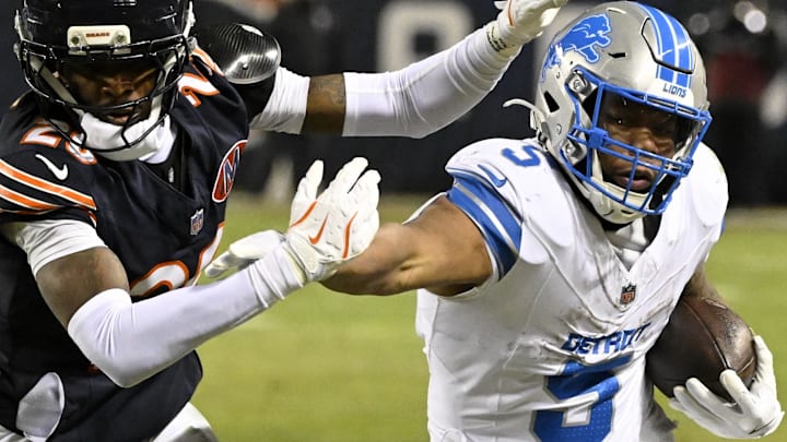 Jan 4, 2026; Chicago, Illinois, USA; Detroit Lions running back David Montgomery (5) runs with the ball against Chicago Bears cornerback Nahshon Wright (26) during the second half at Soldier Field. Mandatory Credit: Matt Marton-Imagn Images