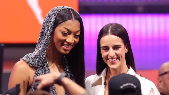 Angel Reese and Caitlin Clark pose for photos before the 2024 WNBA Draft at Brooklyn Academy of Music. 