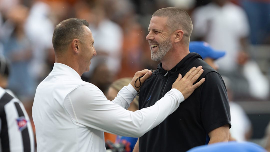 Texas head coach Steve Sarkisian, left, and Florida head coach Billy Napier meet mid field before an NCAA football game in Gainesville, FL on Saturday, October 4, 2025. [Alan Youngblood/Gainesville Sun]