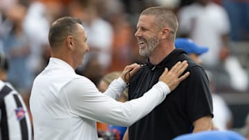 Texas head coach Steve Sarkisian, left, and Florida head coach Billy Napier meet mid field before an NCAA football game in Gainesville, FL on Saturday, October 4, 2025. [Alan Youngblood/Gainesville Sun]