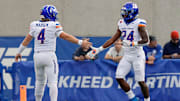 Boise State running back Dylan Riley (24) celebrates with quarterback Maddux Madsen.
