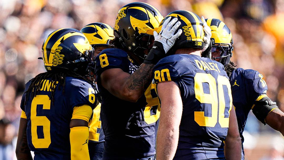 Michigan defensive end Dom Nichols and defensive end John Henry Daley celebrates a play against Iowa