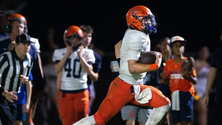 Benjamin quarterback Jayden Vega runs the ball against Cardinal Newman during their regional semifinal playoff football game in West Palm Beach on November 17, 2023.