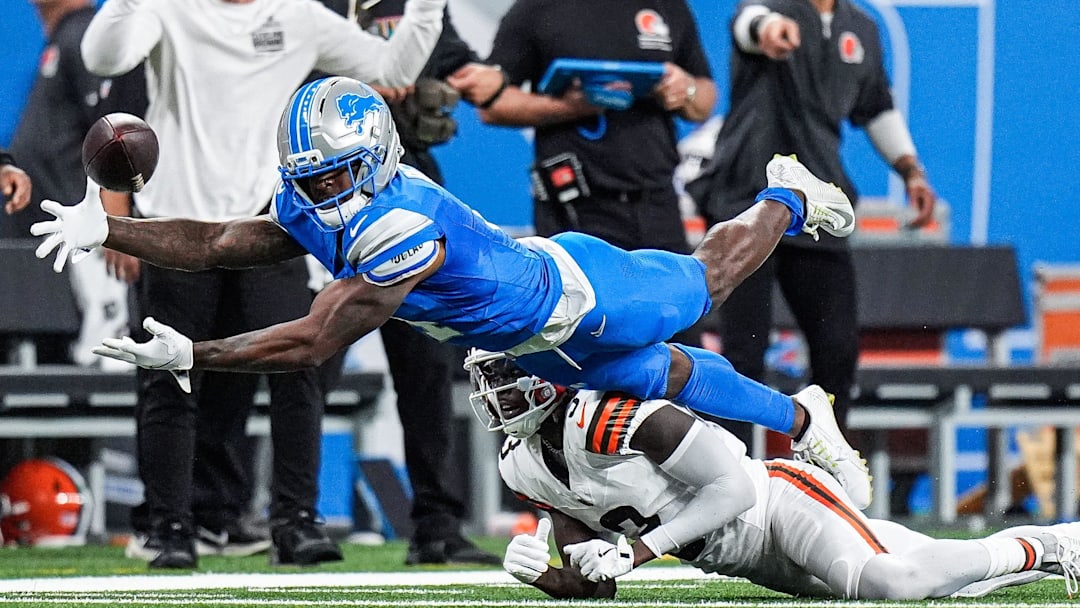 Detroit Lions cornerback D.J. Reed (4) catches for an interception against Cleveland Browns wide receiver Jerry Jeudy (3) during the first half at Ford Field in Detroit on Sunday, Sept. 28, 2025.