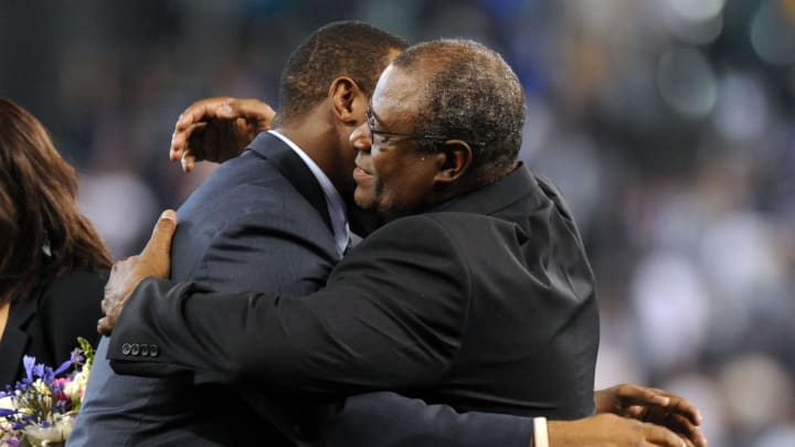 Seattle Mariners former outfielder Ken Griffey Jr. hugs his father Ken Griffey Sr. during an induction ceremony into the Seattle Mariners hall of fame before the game between the Seattle Mariners and the Milwaukee Brewers at Safeco Field in 2013.