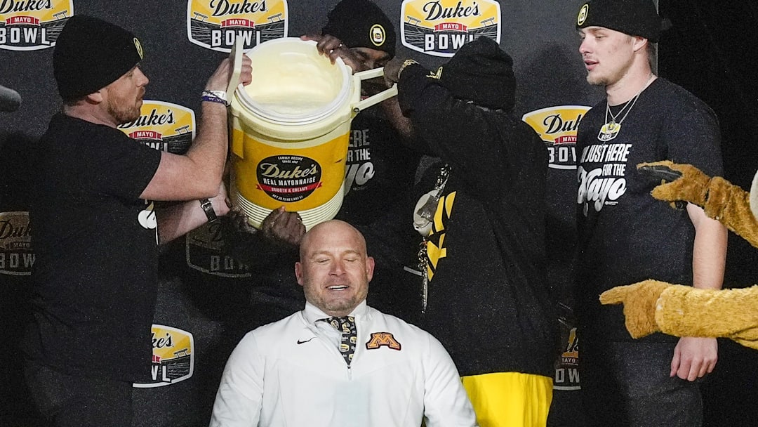 Jan 3, 2025; Charlotte, NC, USA;  Minnesota Golden Gophers head coach P.J. Fleck prepares for the mayo dump after his teams’ win over Virginia Tech Hokies  at the Duke’s Mayo Bowl at Bank of America Stadium. Mandatory Credit: Jim Dedmon-Imagn Images
