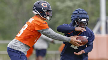 Chicago Bears quarterback Caleb Williams (18) passes the ball to running back D'Andre Swift (4) during minicamp at Halas Hall.