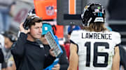 Nov 23, 2025; Glendale, Arizona, USA; Jacksonville Jaguars offensive coordinator Grant Udinski with quarterback Trevor Lawrence (16) against the Arizona Cardinals at State Farm Stadium. Mandatory Credit: Mark J. Rebilas-Imagn Images