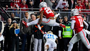 Ohio State Buckeyes running back James Peoples (20) hurdles over UCLA Bruins defensive back Cole Martin (21) in the first half of the NCAA college football game at Ohio Stadium on Saturday, Nov. 15, 2025 in Columbus, Ohio.