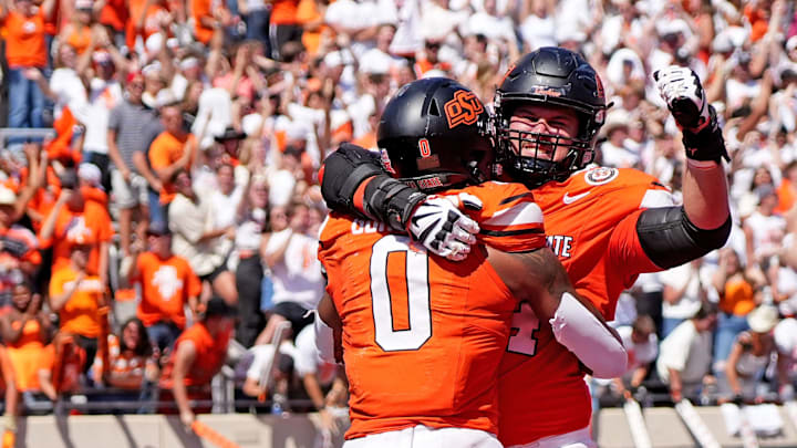 Oklahoma State's Ollie Gordon II (0) celebrates a touchdown with Preston Wilson (74) in double over time of the college football game between the Oklahoma State Cowboys and the Arkansas Razorbacks at Boone Pickens Stadium in Stillwater, Okla.,, Saturday, Sept., 7, 2024.