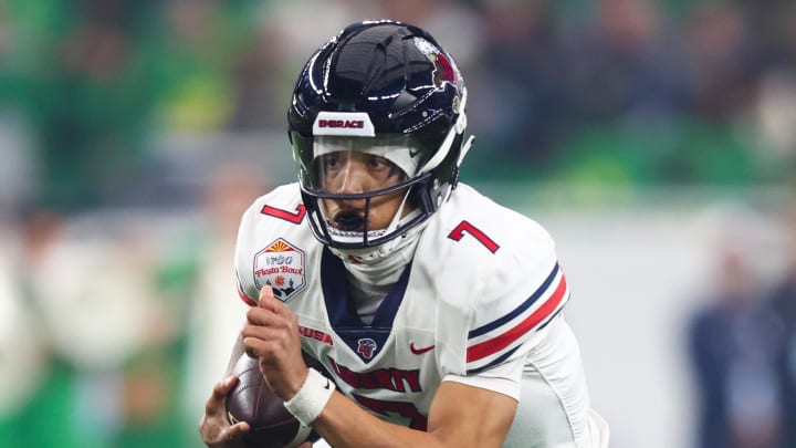 Jan 1, 2024; Glendale, AZ, USA; Liberty Flames quarterback Kaidon Salter (7) runs with the ball against the Oregon Ducks during the first quarter in the 2024 Fiesta Bowl at State Farm Stadium. Mandatory Credit: Mark J. Rebilas-USA TODAY Sports