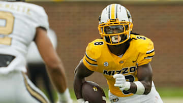 Sep 21, 2024; Columbia, Missouri, USA; Missouri Tigers running back Nate Noel (8) runs with the ball against Vanderbilt Commodores linebacker Randon Fontenette (2) during the first half at Faurot Field at Memorial Stadium. Mandatory Credit: Jay Biggerstaff-Imagn Images