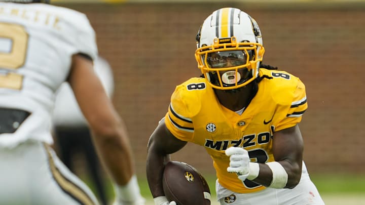 Sep 21, 2024; Columbia, Missouri, USA; Missouri Tigers running back Nate Noel (8) runs with the ball against Vanderbilt Commodores linebacker Randon Fontenette (2) during the first half at Faurot Field at Memorial Stadium. Mandatory Credit: Jay Biggerstaff-Imagn Images